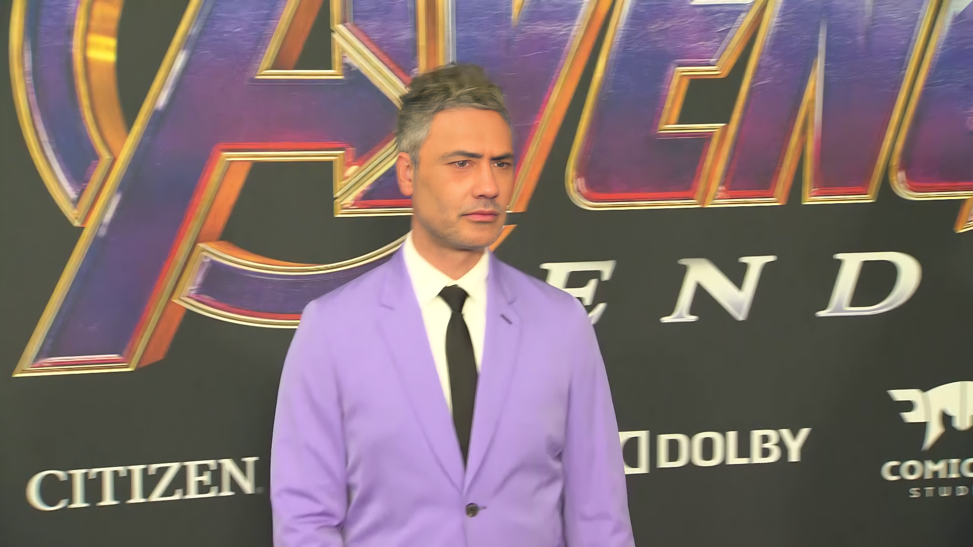 A purple suit made a colorful statement. His playful personality completed the look.